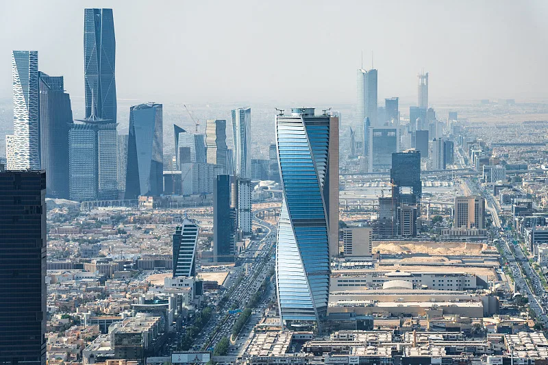 Aerial view of KAFD — King Abdullah Financial District skyline with Kingdom Tower, glass skyscrapers, and multi-lane highway